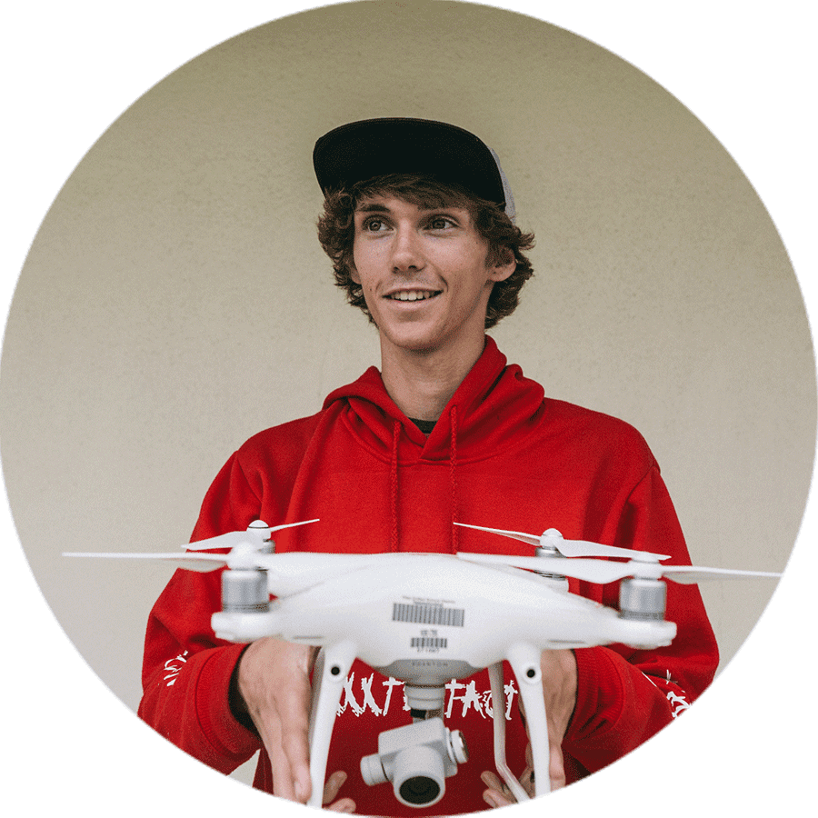 a student holding a drone