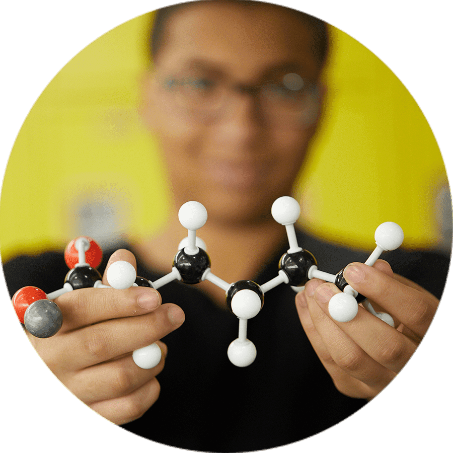 a student holding a model of a molecule