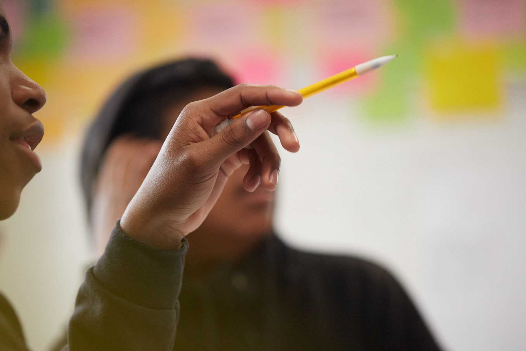 a student pointing with a pencil