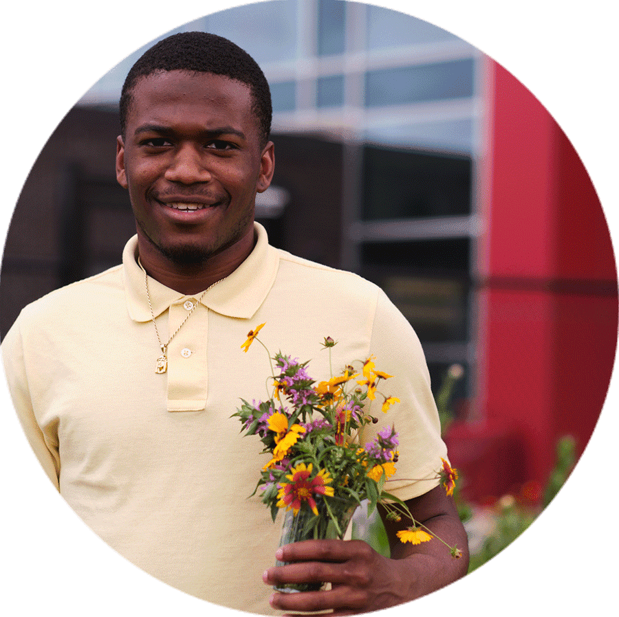 student holding flowers