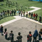Students gathered and forming a circle in a high school park