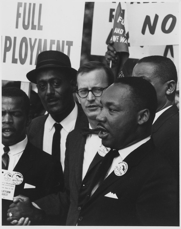 Dr. Martin Luther King, Jr. speaking during the March on Washington for Jobs and Freedom in 1963 alongside John Lewis and Mathew Ahman