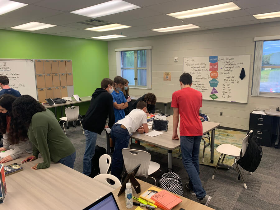 Students in a PBL classroom at PSI High collaborating and practicing design thinking