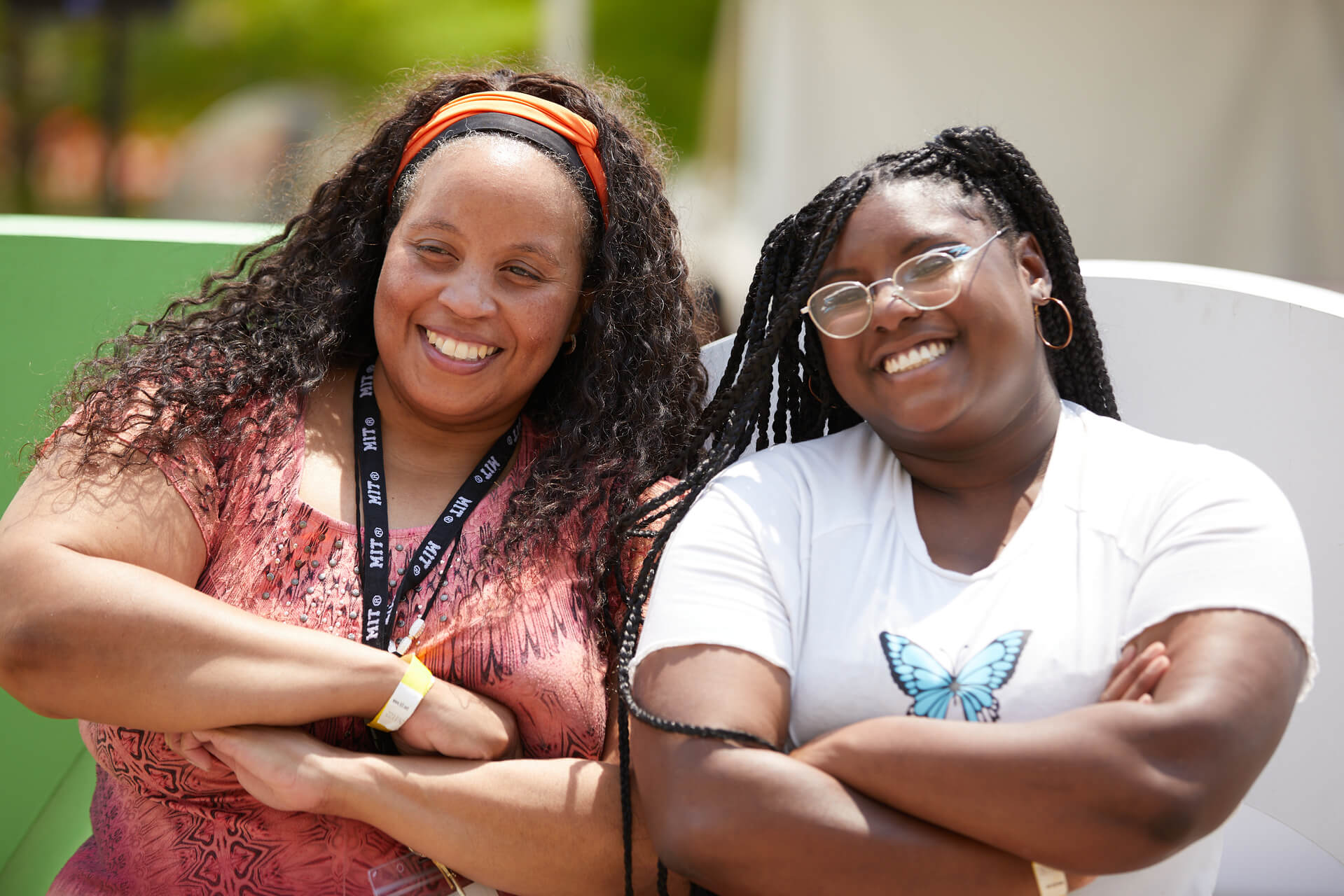 Educator Nikki Wallace smiling and posing for a picture with a female student