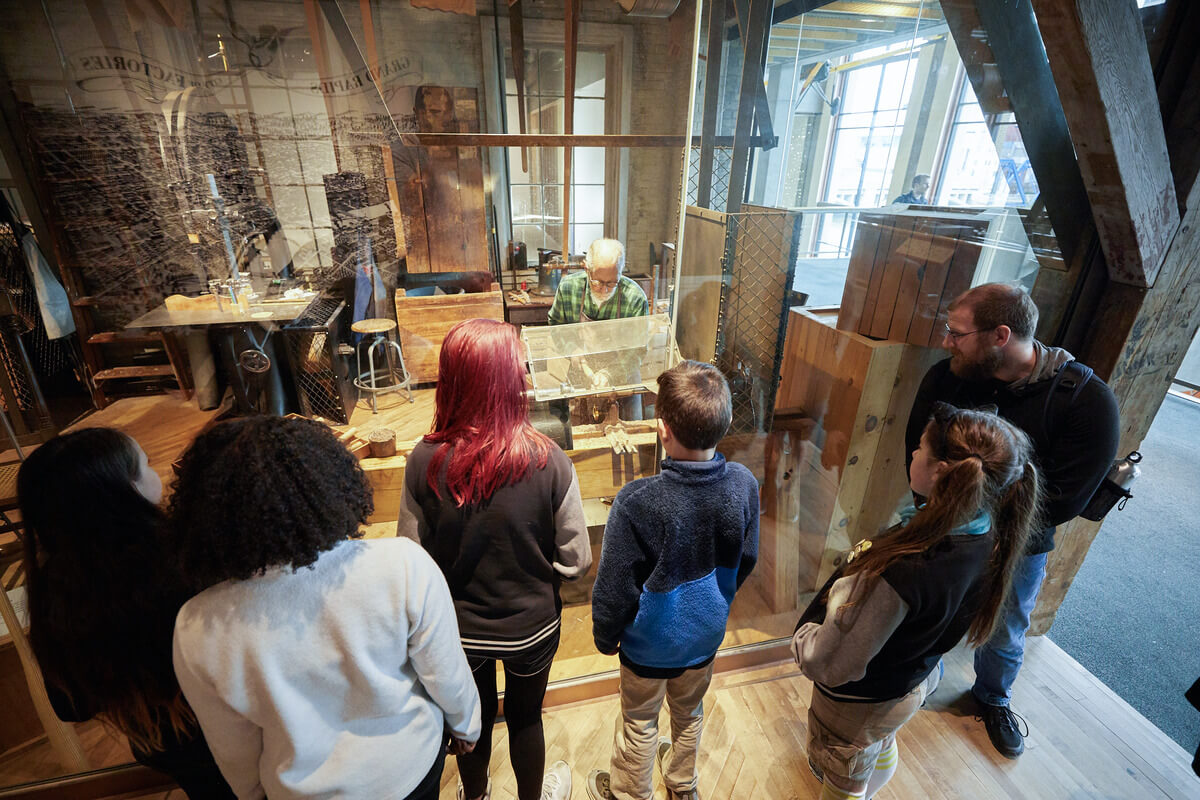 students at the Grand Rapids Public Museum School visit a local carpenter restoring vintage furniture