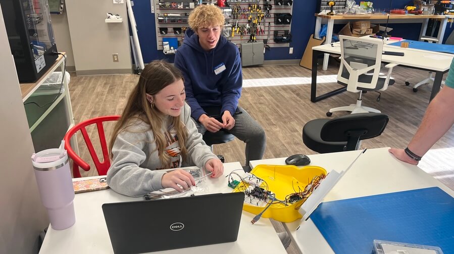 two students working on a electronic project