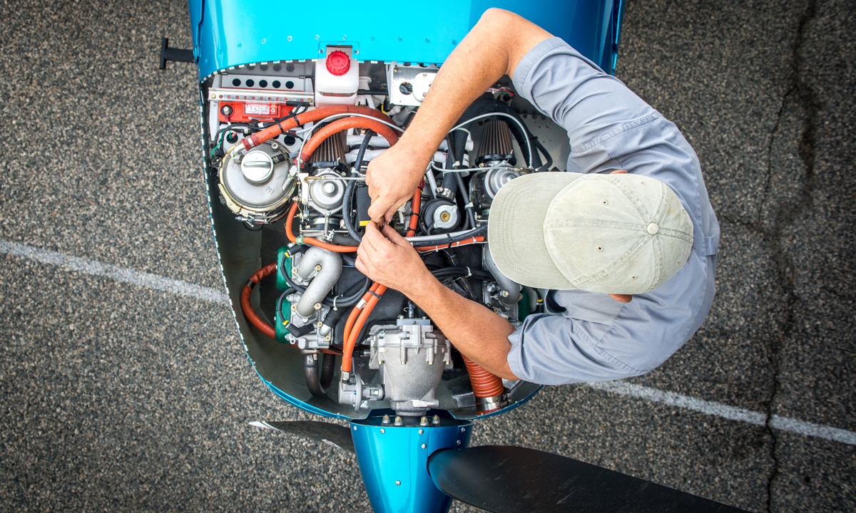 Person working on plane engine